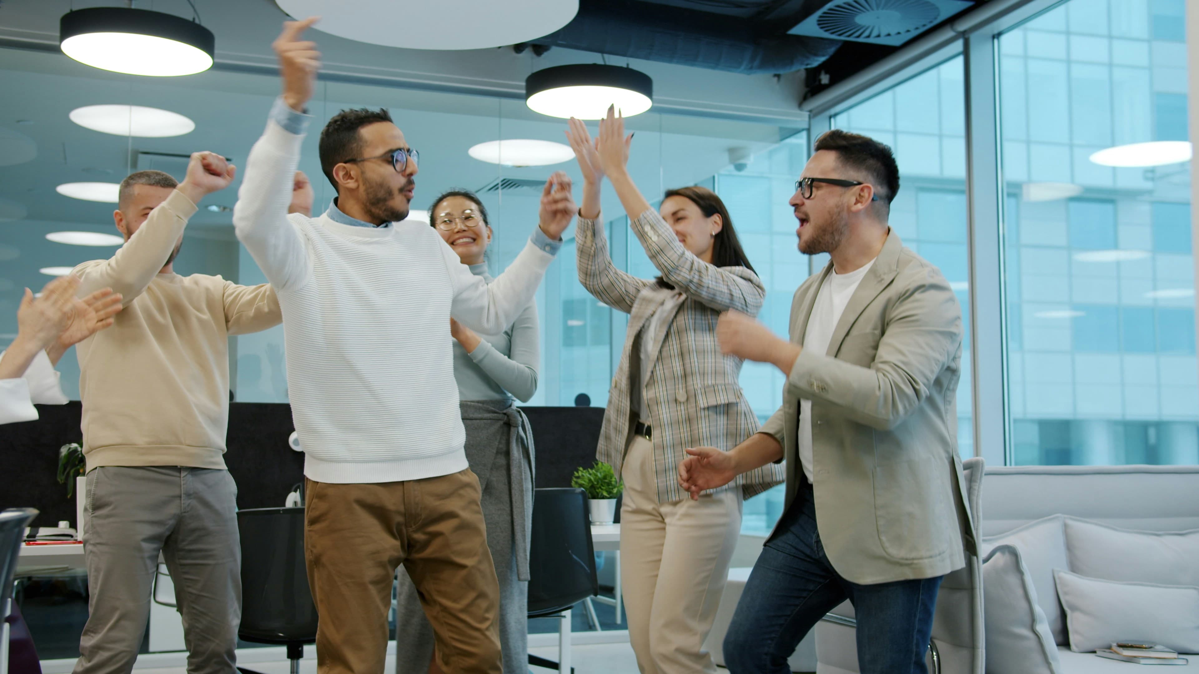 A team celebrating together in a modern office