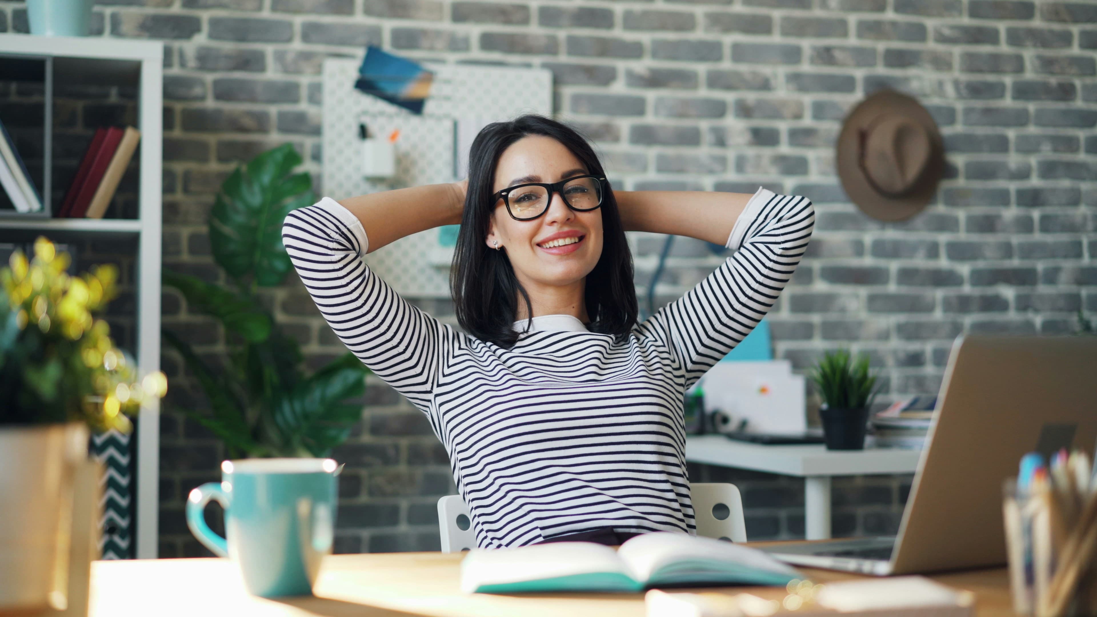 An employee relaxed at their desk after a virtual wellness session